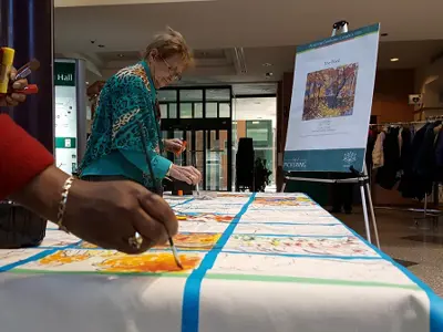 People painting on the Community Canvas