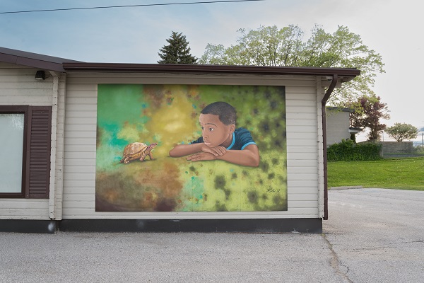 The temporary mural “Curiosity” by Hallie A. Ndorley located at West Shore Community Centre, Pickering.