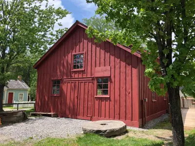 red painted building with small trees surrounding