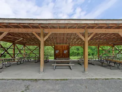 picnic tables under a wooden structure